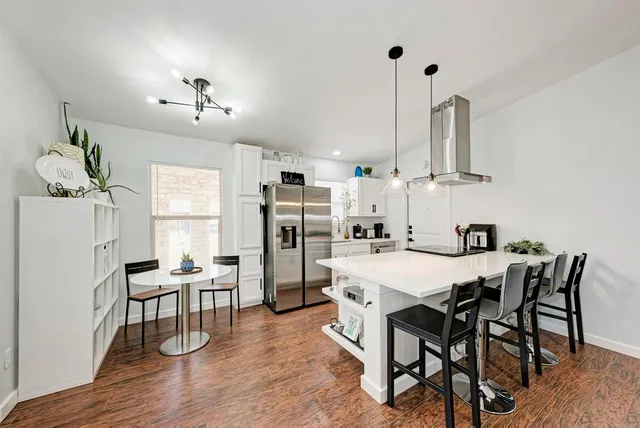 a view of a dining room with furniture and wooden floor