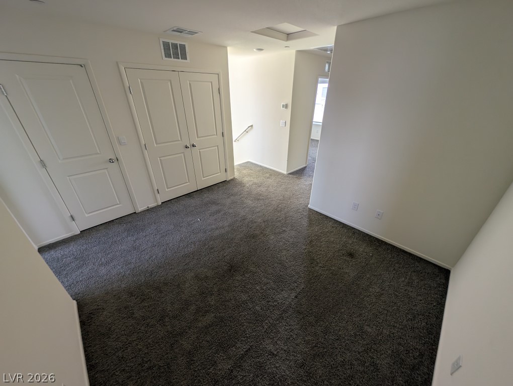 4820 Orchid Rdg Avenue Las Vegas, NV 89141 - Photo 6 of 16 A well-lit landing features soft carpeting and ample storage options with classic white doors.