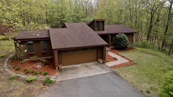 a view of a house with backyard and sitting area