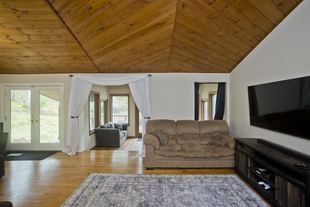 32 Zuell Hill Road Monson, MA 01057 - Photo 15 of 37 a living room with furniture and a flat screen tv