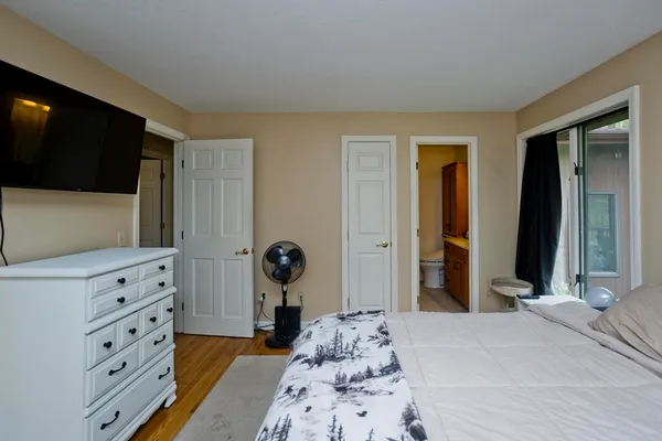 a bedroom with a bed and a television