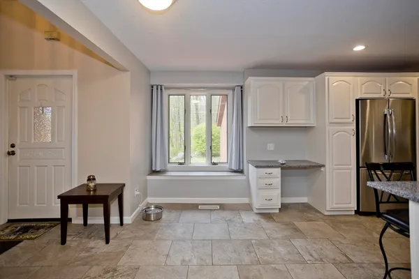 a kitchen with a refrigerator a stove a sink and a cabinets