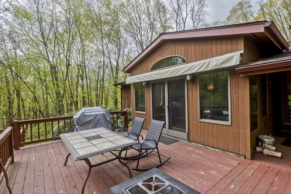 32 Zuell Hill Road Monson, MA 01057 - Photo 30 of 37 a view of a patio with table and chairs with wooden floor and fence