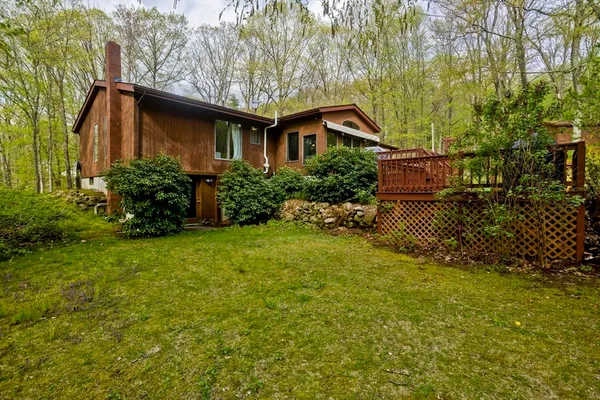 a backyard of a house with table and chairs