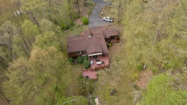 an aerial view of a house with a yard