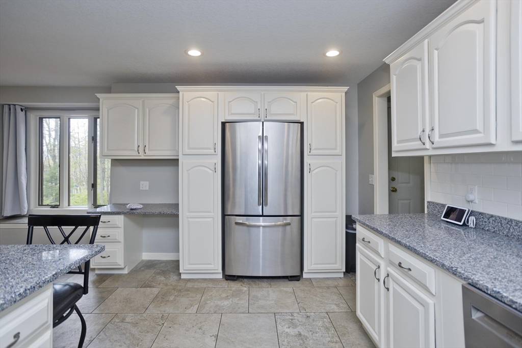 32 Zuell Hill Road Monson, MA 01057 - Photo 5 of 37 a kitchen with granite countertop a refrigerator and wooden cabinets