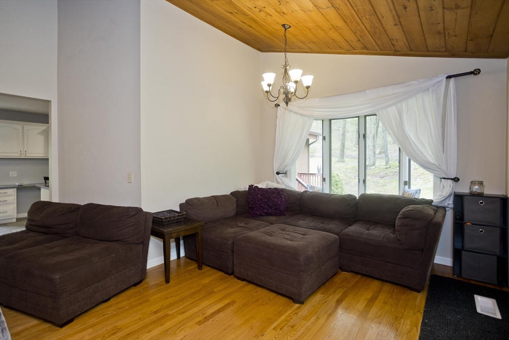 32 Zuell Hill Road Monson, MA 01057 - Photo 8 of 37 a living room with furniture a chandelier and a dining table