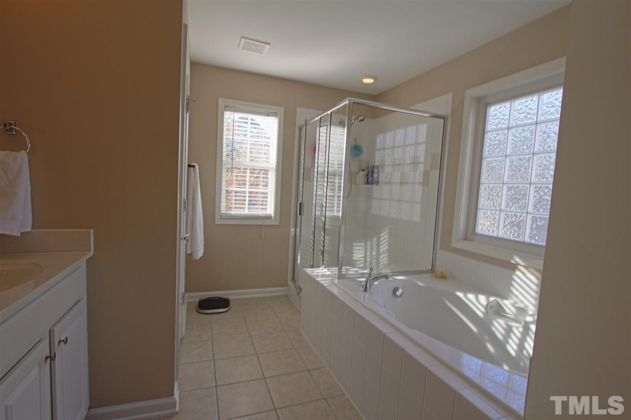 4 Providence Ridge Road Durham, NC 27713 - Photo 14 of 25 a bathroom with a bathtub and a sink