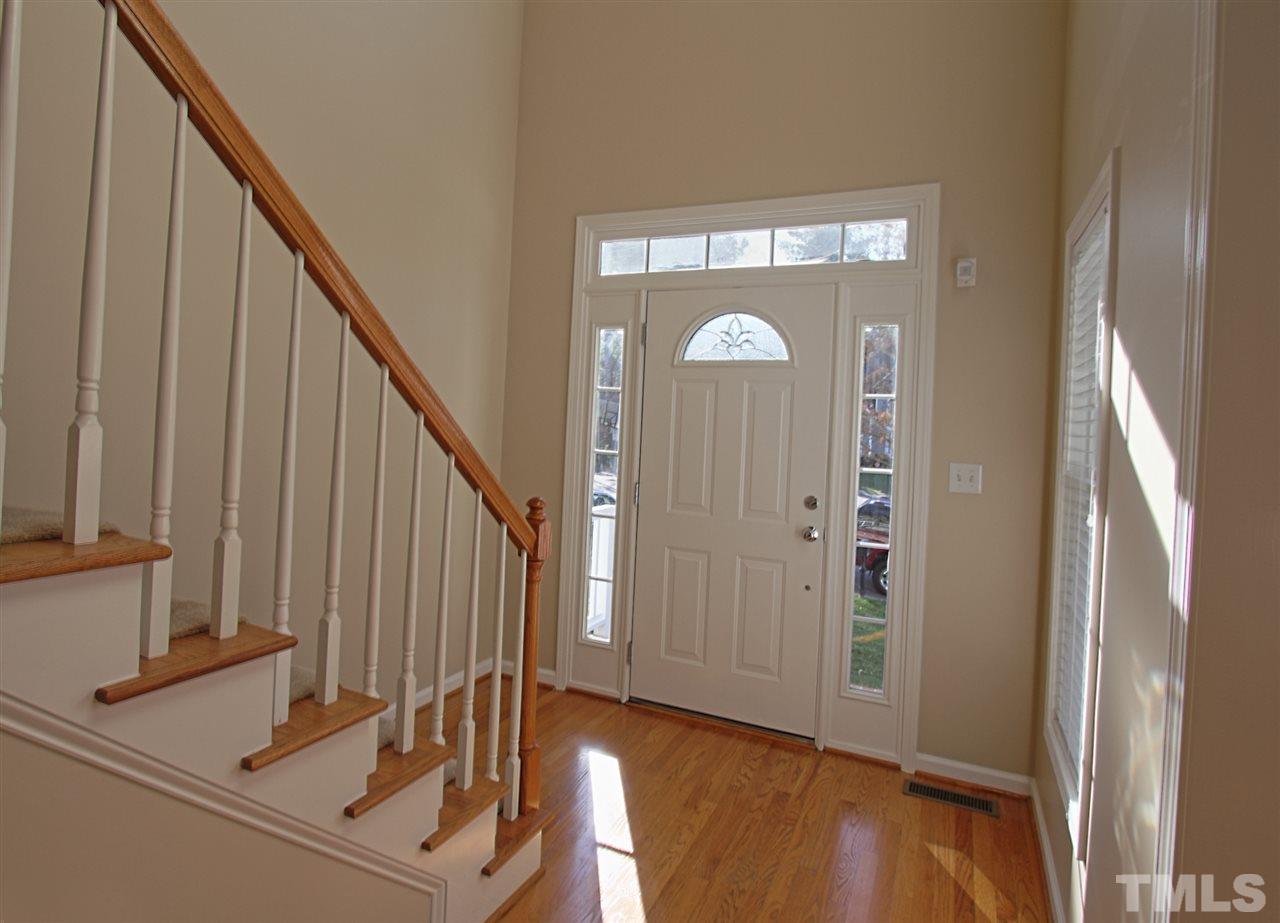4 Providence Ridge Road Durham, NC 27713 - Photo 3 of 25 a view of a hallway with wooden floor and entryway