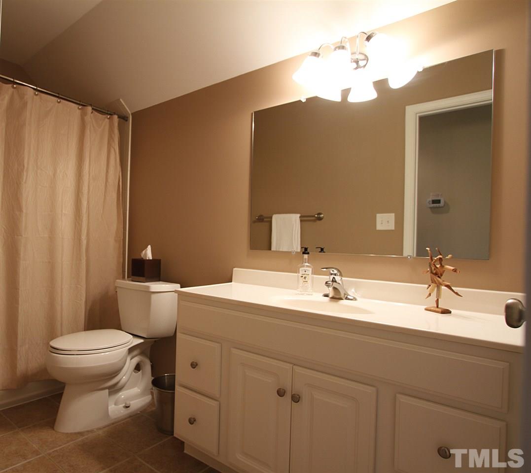 4 Providence Ridge Road Durham, NC 27713 - Photo 22 of 25 a bathroom with a double vanity sink toilet and a mirror