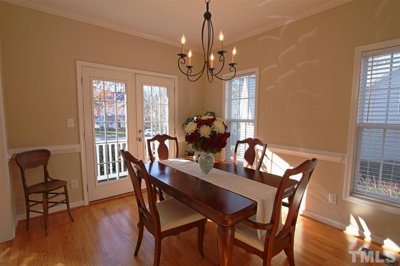 4 Providence Ridge Road Durham, NC 27713 - Photo 6 of 25 a dining room with furniture a chandelier and wooden floor
