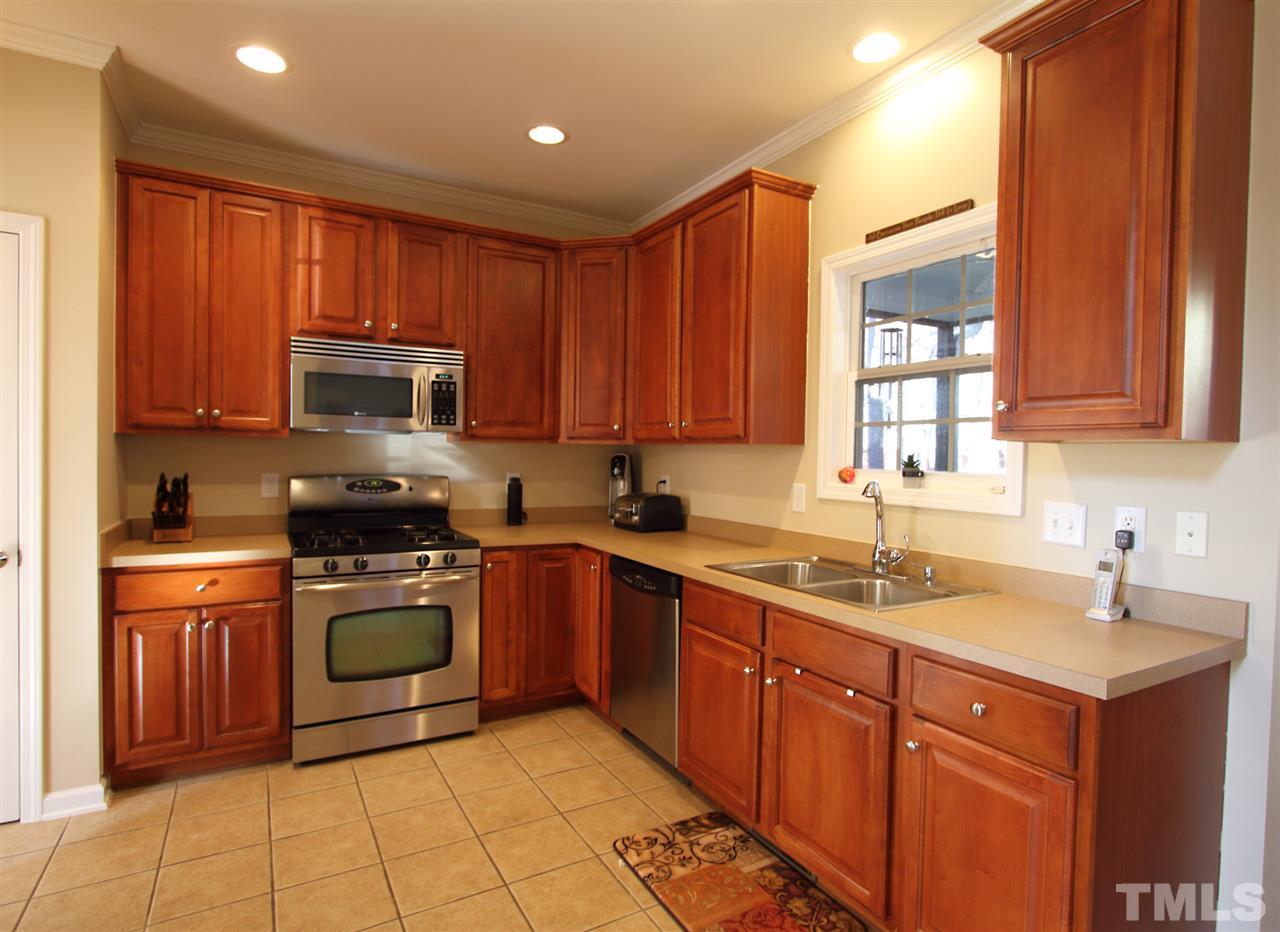 4 Providence Ridge Road Durham, NC 27713 - Photo 7 of 25 a kitchen with stainless steel appliances granite countertop a sink stove and microwave