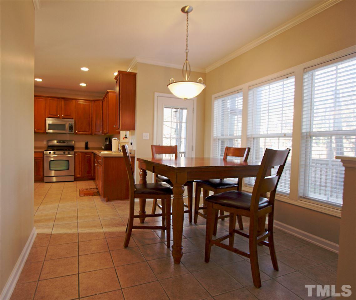 4 Providence Ridge Road Durham, NC 27713 - Photo 9 of 25 a dining room with furniture a chandelier and a rug