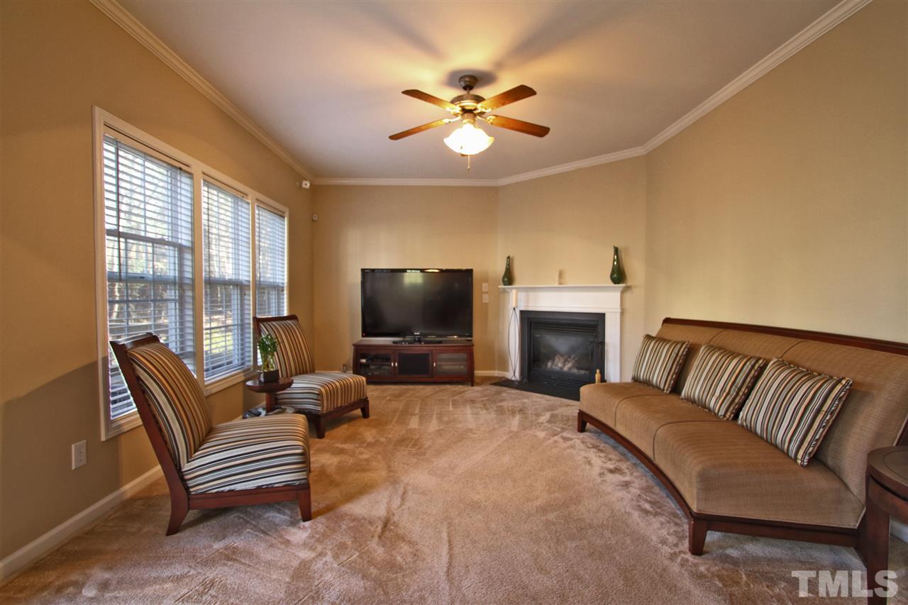 4 Providence Ridge Road Durham, NC 27713 - Photo 10 of 25 a living room with furniture a fireplace and a flat screen tv