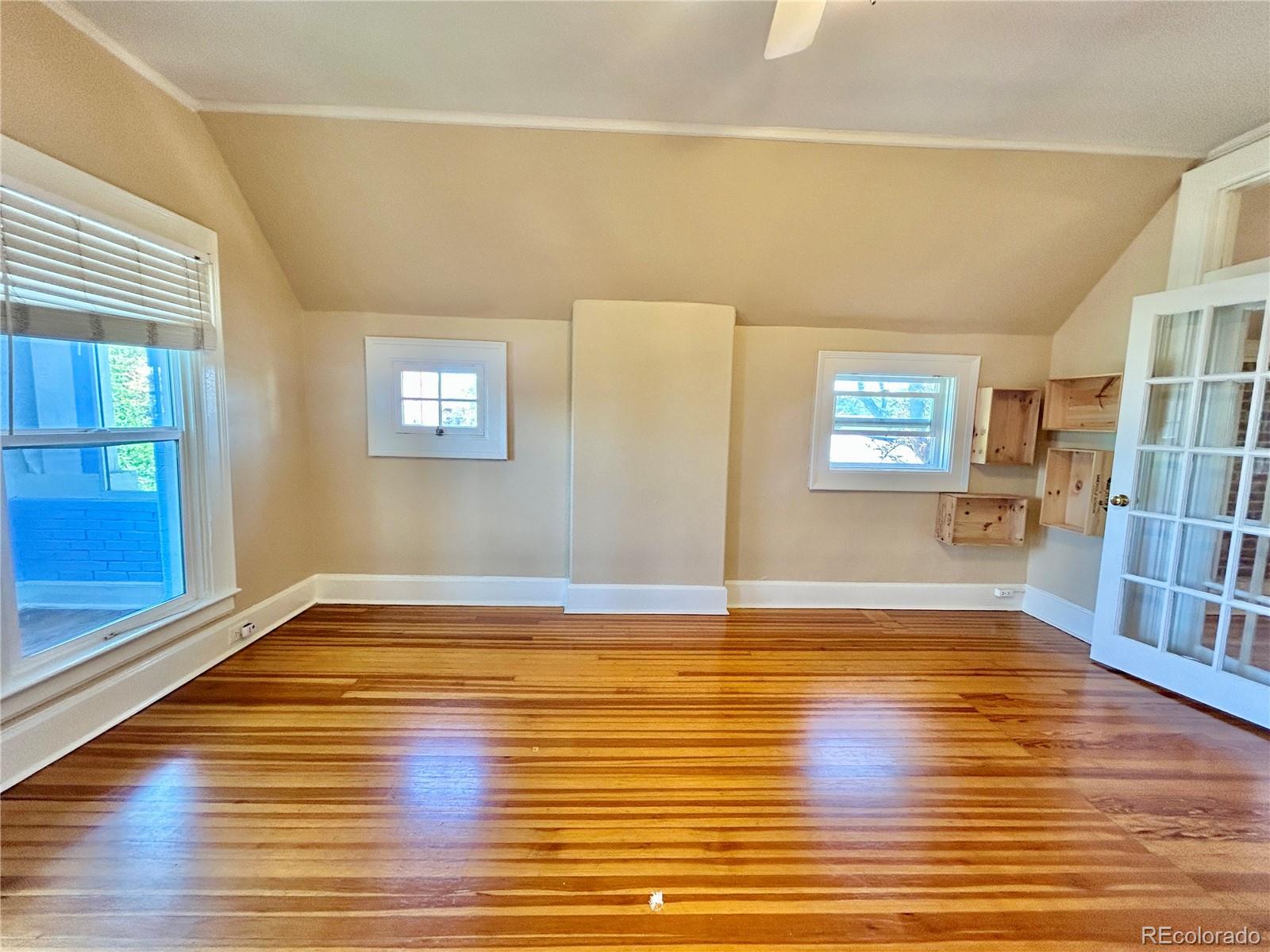 16-th 16-th E 16th Denver, CO 80203 - Photo 12 of 38 a view of an empty room with wooden floor and a window
