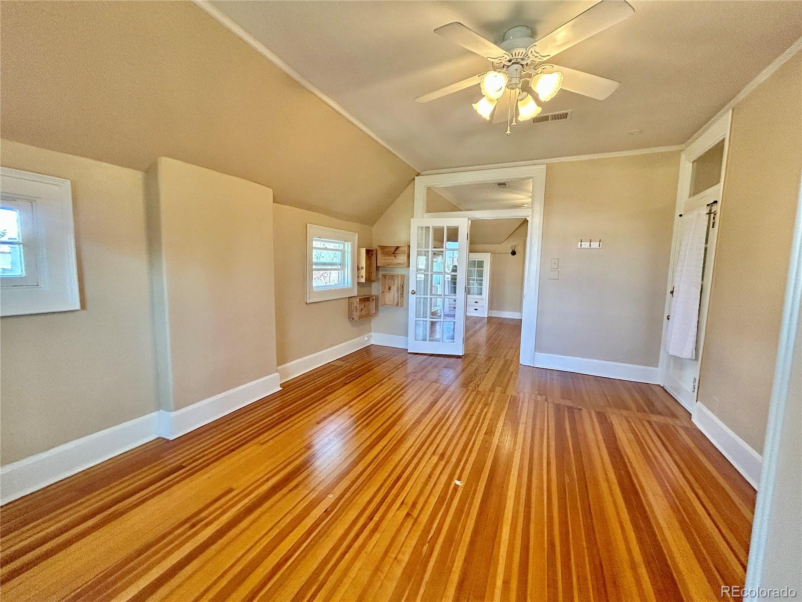 16-th 16-th E 16th Denver, CO 80203 - Photo 13 of 38 a view of a room with wooden floor and a ceiling fan