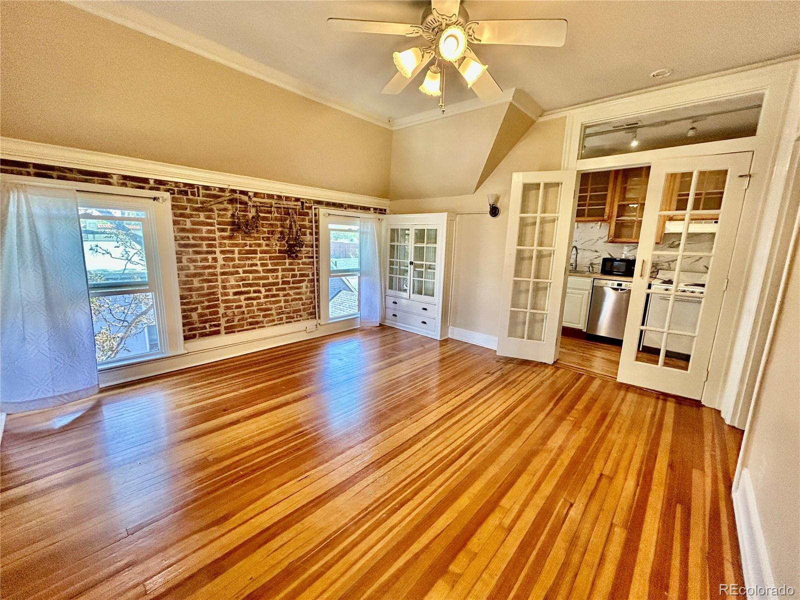 16-th 16-th E 16th Denver, CO 80203 - Photo 15 of 38 wooden floor in an empty room with a fireplace