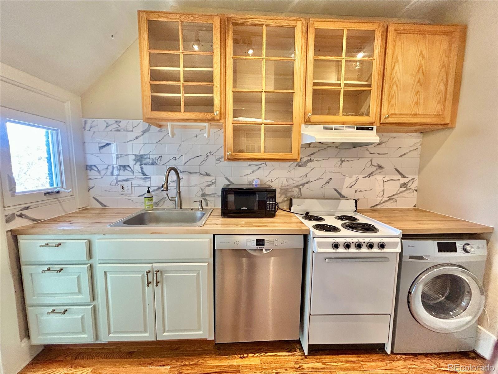 16-th 16-th E 16th Denver, CO 80203 - Photo 16 of 38 a kitchen with a stove and a sink