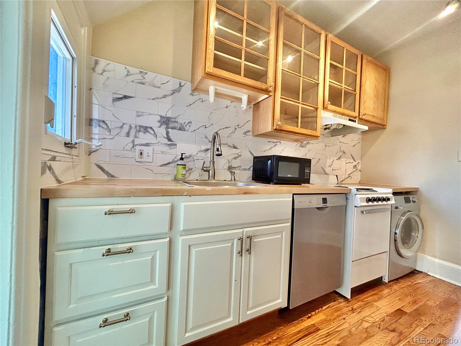 16-th 16-th E 16th Denver, CO 80203 - Photo 17 of 38 a bathroom with a sink and a mirror