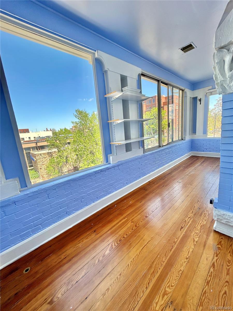 16-th 16-th E 16th Denver, CO 80203 - Photo 26 of 38 a view of room with window and wooden floor