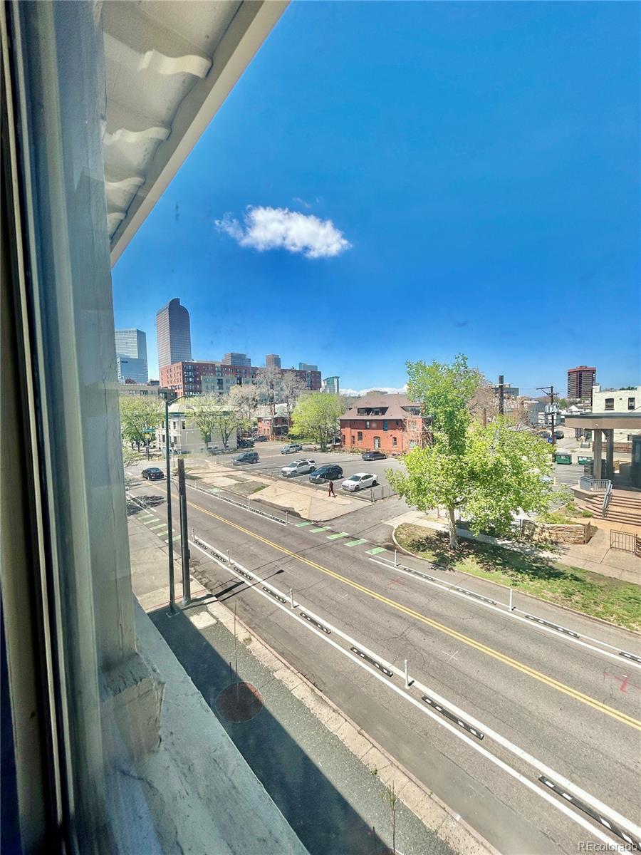 16-th 16-th E 16th Denver, CO 80203 - Photo 29 of 38 a view of a living room with a floor to ceiling window and a kitchen
