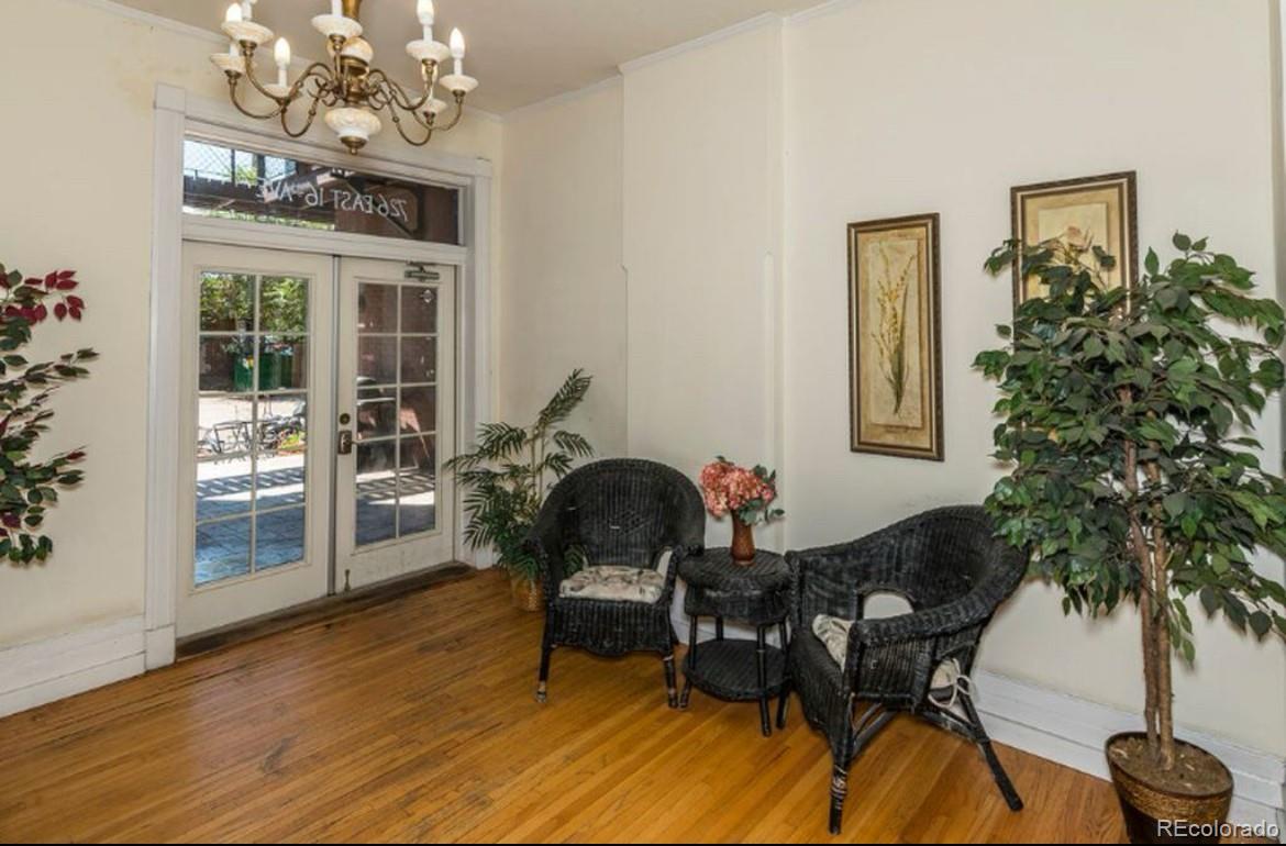 16-th 16-th E 16th Denver, CO 80203 - Photo 3 of 38 a dining room with furniture a chandelier and wooden floor