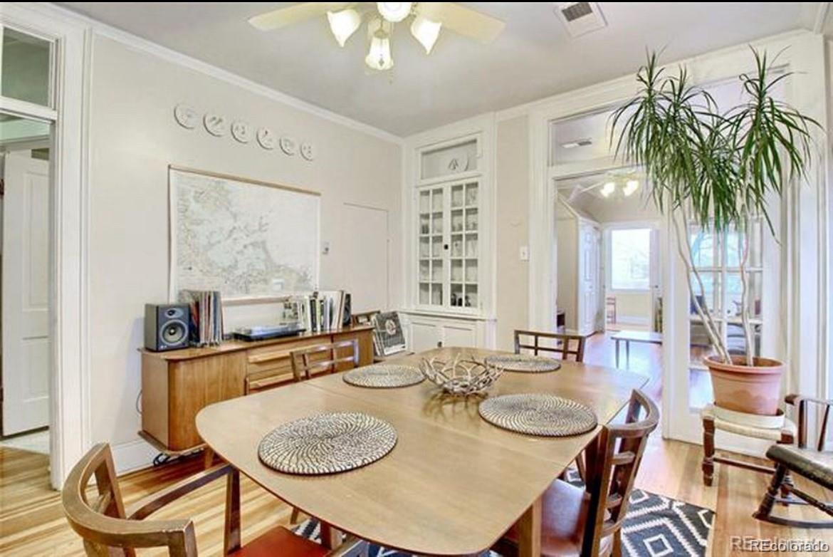 16-th 16-th E 16th Denver, CO 80203 - Photo 9 of 38 a dining room with furniture a large window and wooden floor