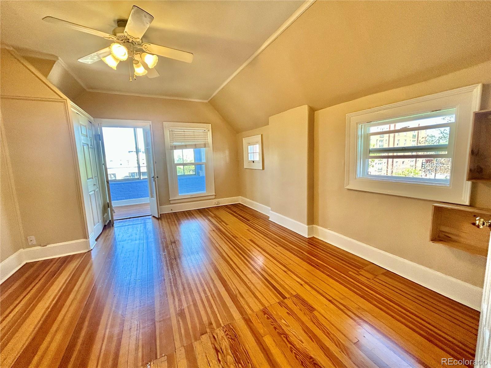 16-th 16-th E 16th Denver, CO 80203 - Photo 10 of 38 a view of an empty room with wooden floor and a window