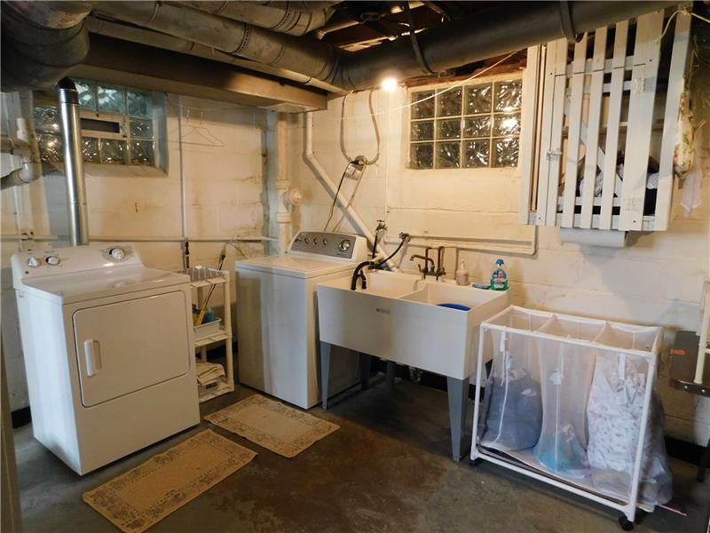 2367 Collins Road Pittsburgh, PA 15235 - Photo 20 of 25 Basement laundry area with Whirlpool appliances, new double utility sink, and laundry chute.