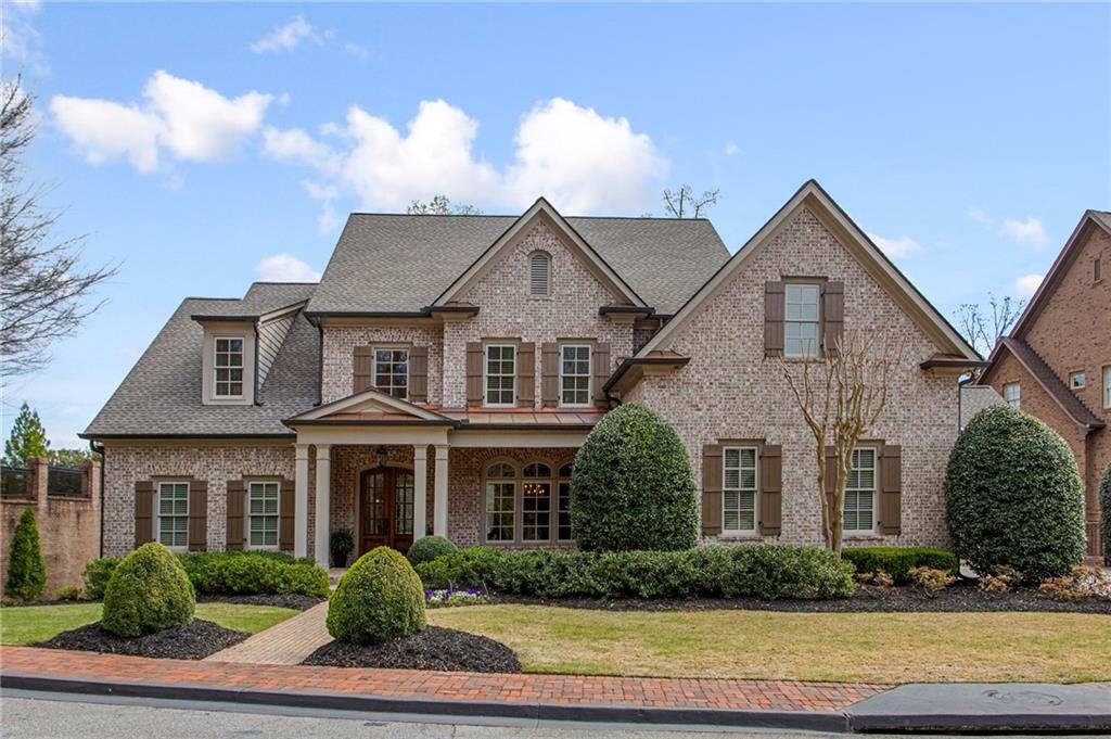 a front view of a house with plants and entryway