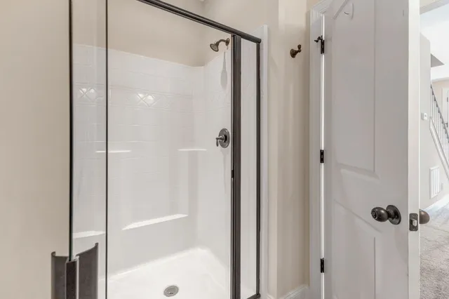 a bathroom with a glass shower door
