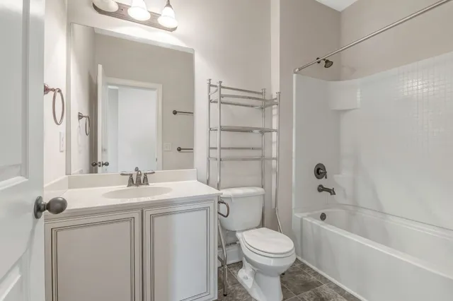 a bathroom with a sink toilet vanity and shower