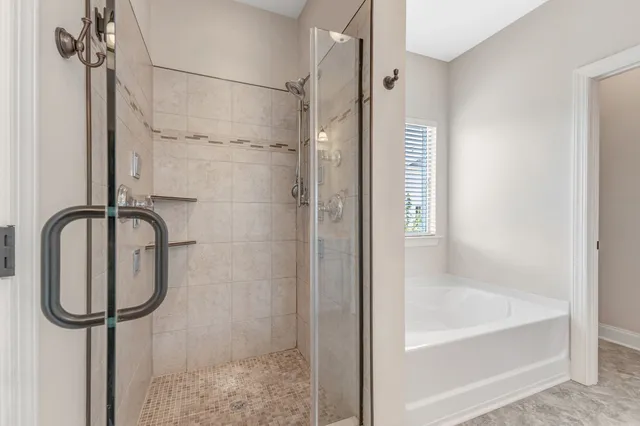 a bathroom with a bathtub and a shower