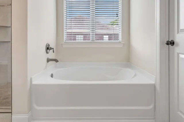 a white bath tub sitting next to a window