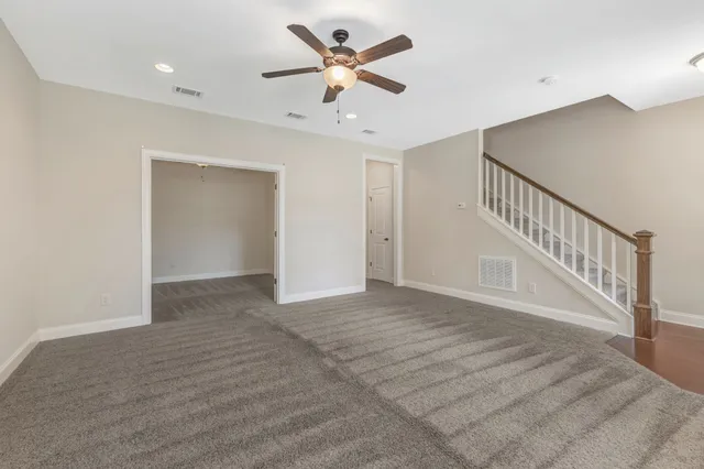a view of an empty room with a ceiling fan
