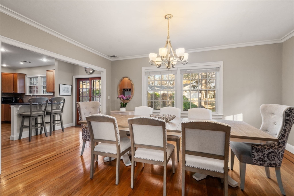 55 Evelyn Road Newton, MA 02468 - Photo 11 of 30 a view of a dining room with furniture wooden floor and chandelier