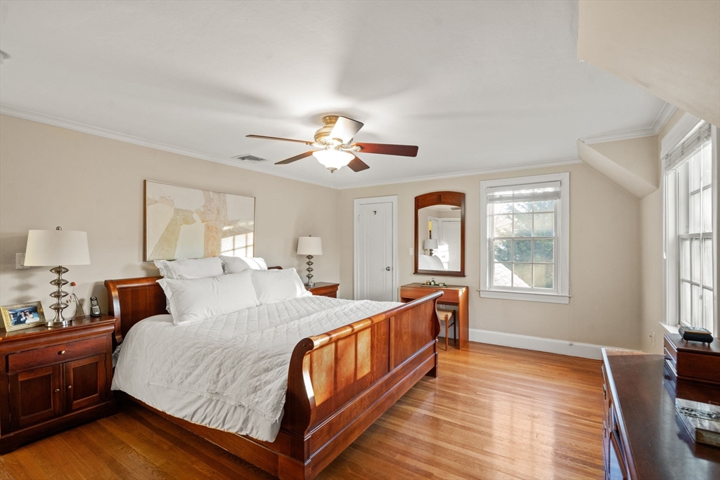 55 Evelyn Road Newton, MA 02468 - Photo 15 of 30 a bedroom with a large bed and a chandelier