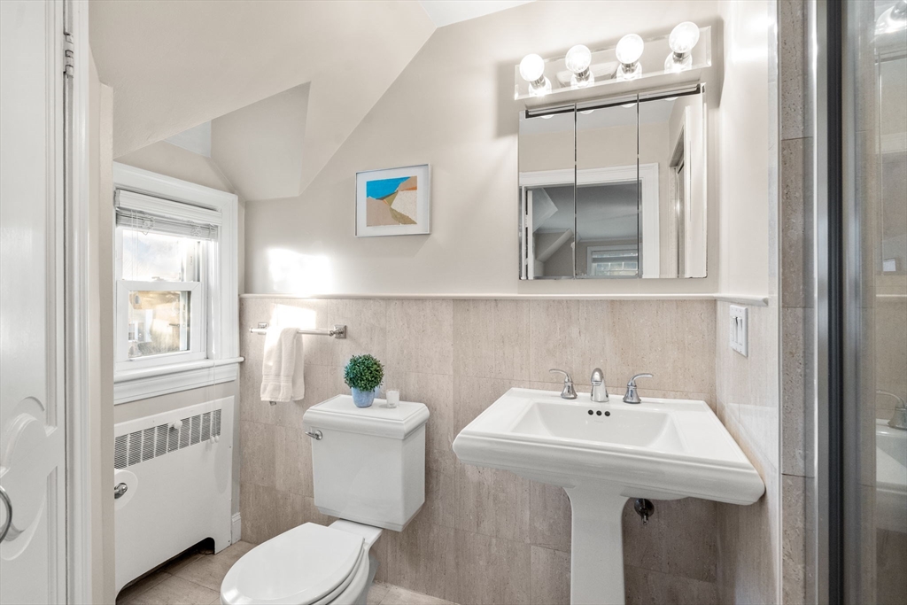 55 Evelyn Road Newton, MA 02468 - Photo 17 of 30 a bathroom with a sink a toilet and a mirror