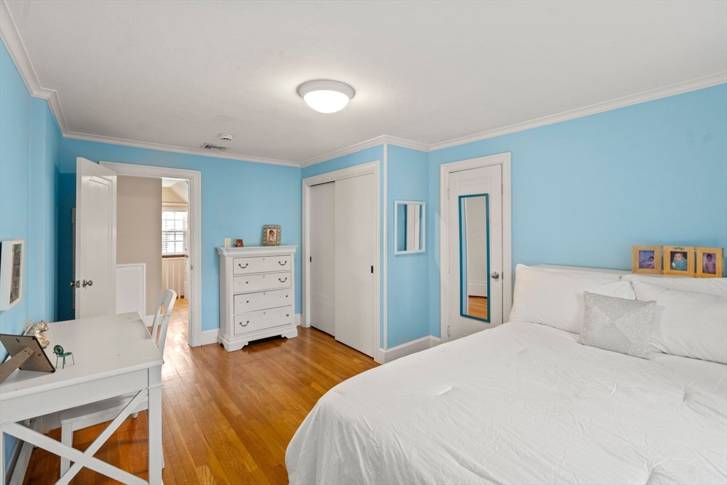 55 Evelyn Road Newton, MA 02468 - Photo 19 of 30 a bedroom with a bed and a television