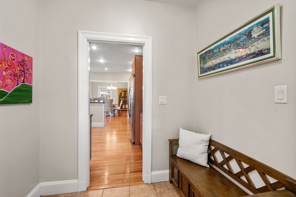 55 Evelyn Road Newton, MA 02468 - Photo 22 of 30 a view of a hallway with wooden floor and a living room