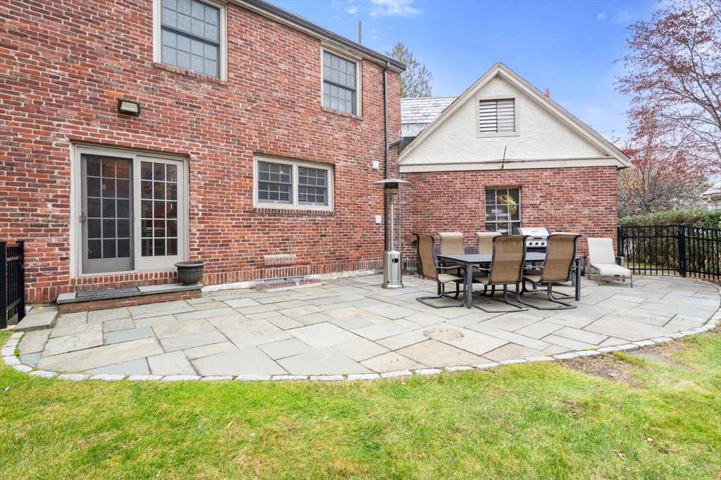 55 Evelyn Road Newton, MA 02468 - Photo 24 of 30 a view of house with backyard and outdoor seating