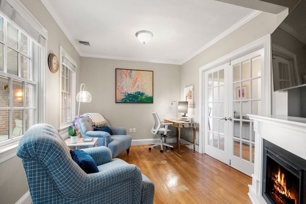 55 Evelyn Road Newton, MA 02468 - Photo 6 of 30 a living room with furniture a fireplace and a large window