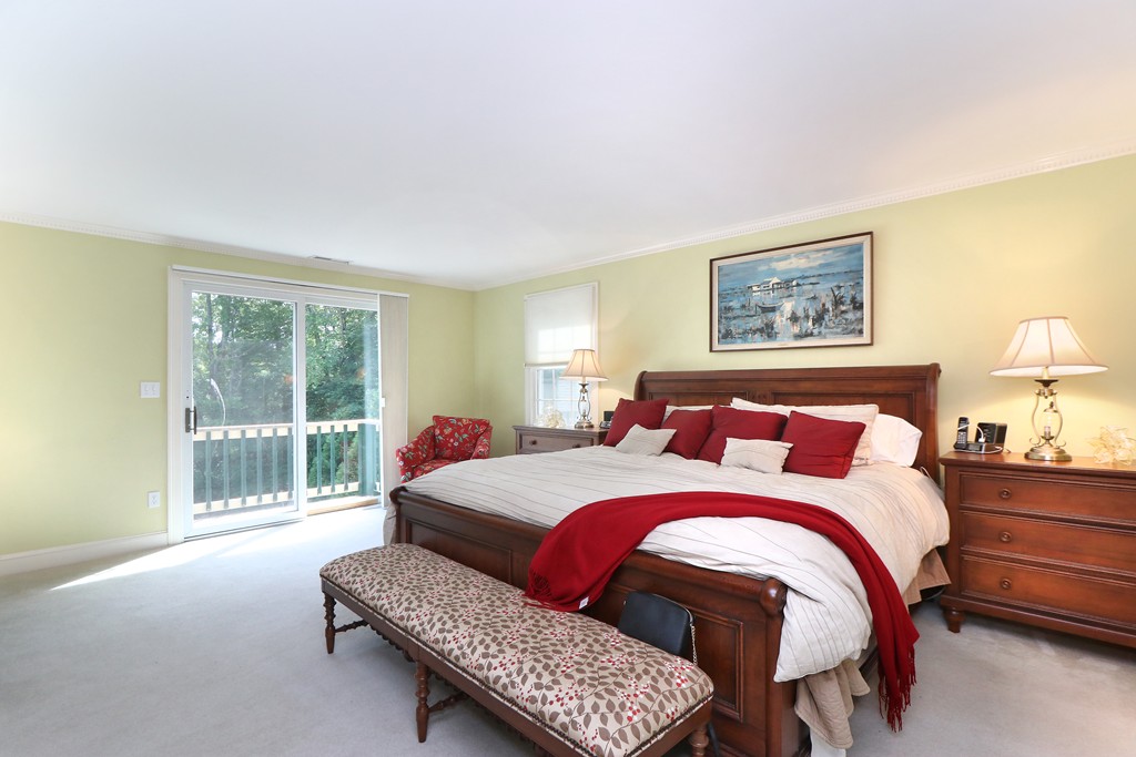 521 Marrett Road Lexington, MA 02421 - Photo 20 of 30 a bedroom with a bed and wooden floor