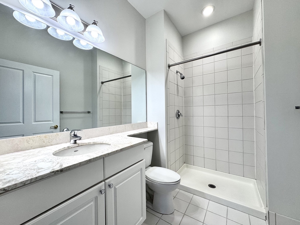 4 Bishop Street, Unit 206 Framingham, MA 01702 - Photo 21 of 28 a bathroom with a sink a toilet and shower