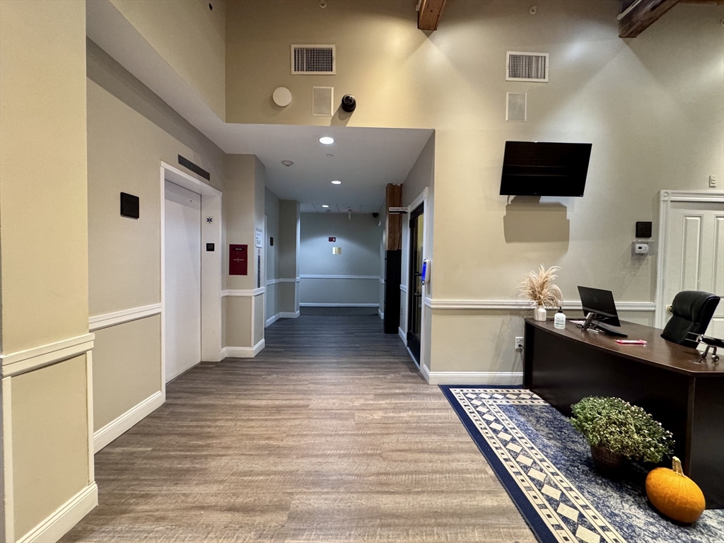 4 Bishop Street, Unit 206 Framingham, MA 01702 - Photo 23 of 28 a kitchen with stainless steel appliances kitchen island granite countertop a refrigerator and a stove top oven