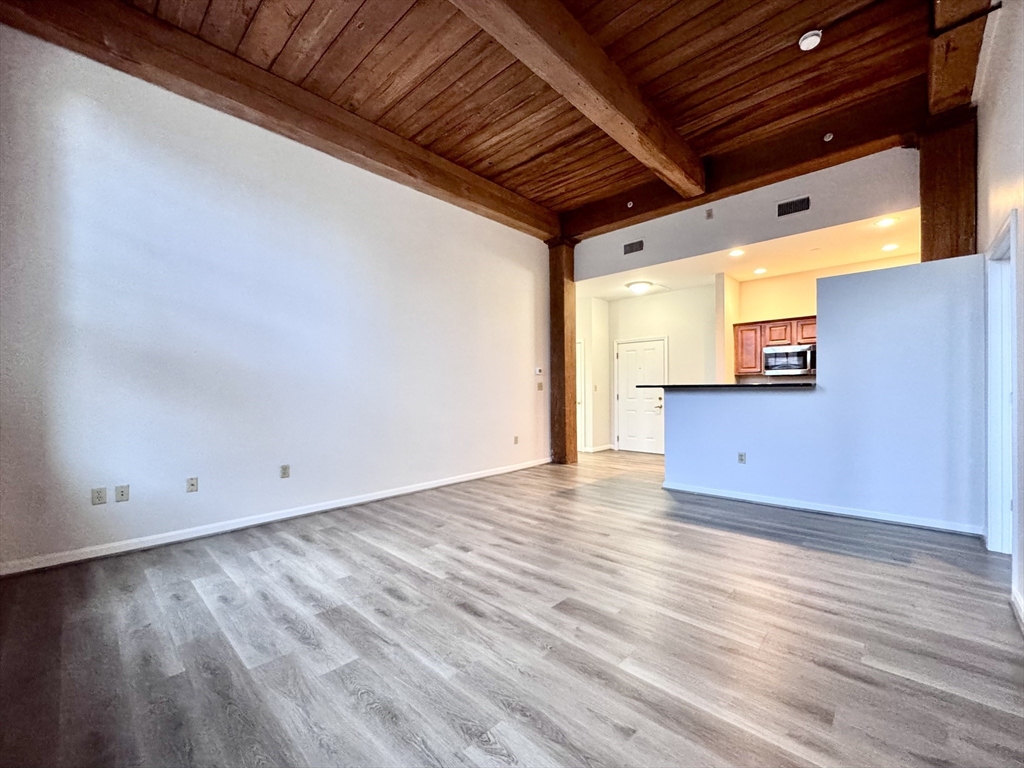 4 Bishop Street, Unit 206 Framingham, MA 01702 - Photo 7 of 28 a view of a livingroom with wooden floor