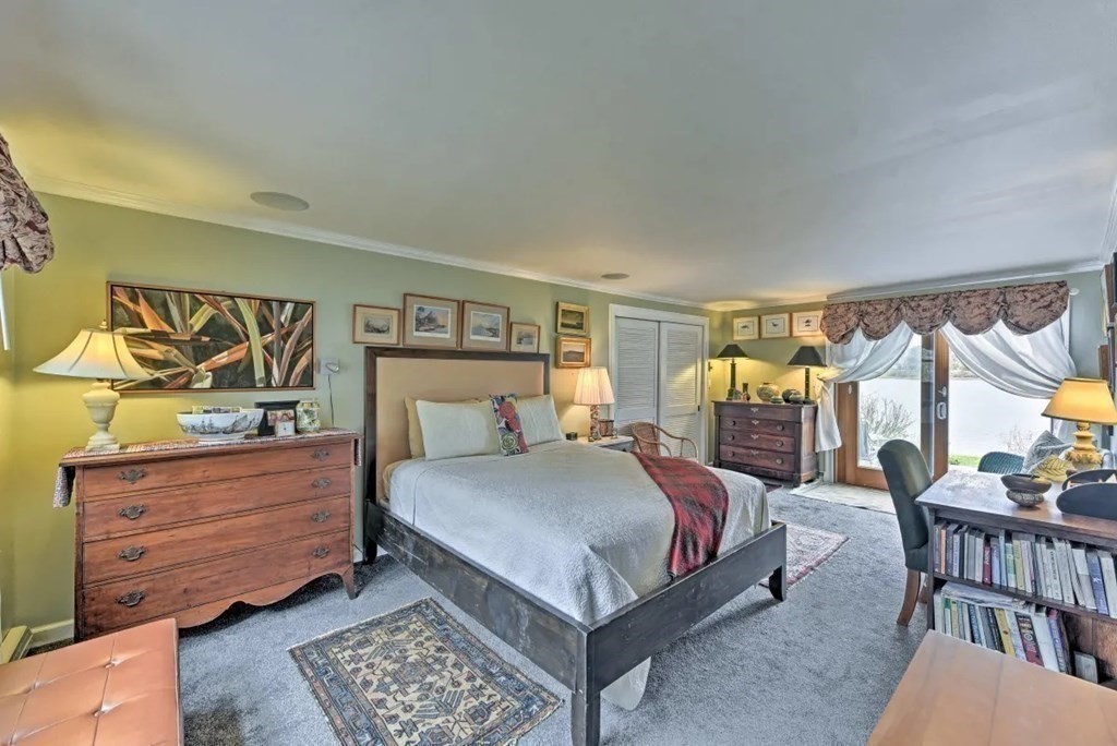 232 Lagoon Pond Road Tisbury, MA 02568 - Photo 17 of 31 a bedroom with a bed table and dresser