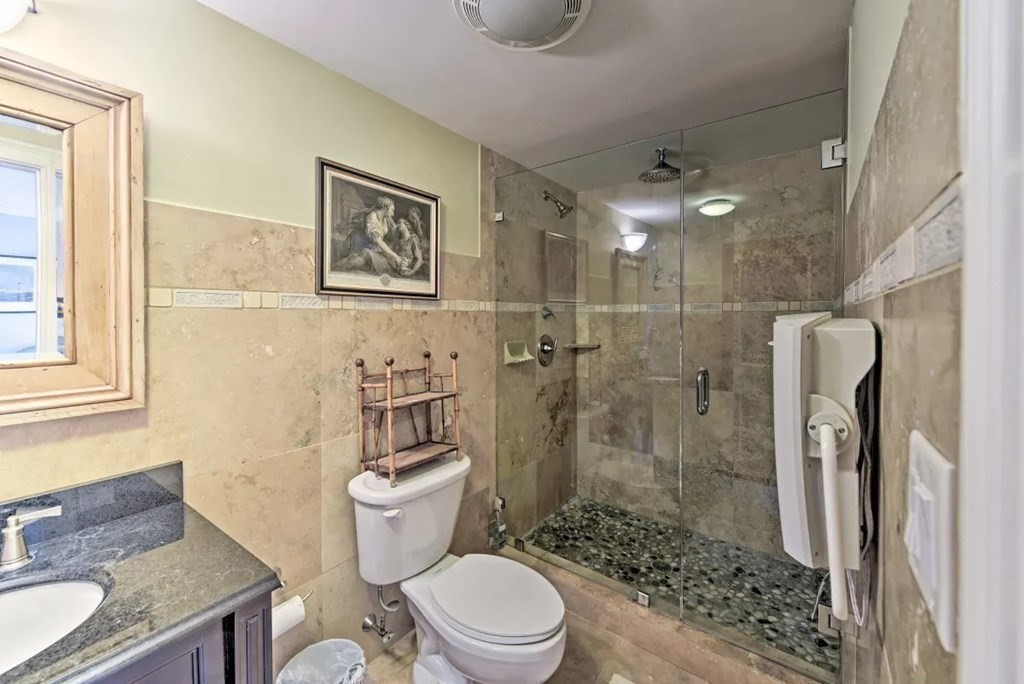 232 Lagoon Pond Road Tisbury, MA 02568 - Photo 19 of 31 a bathroom with a granite countertop sink toilet and shower