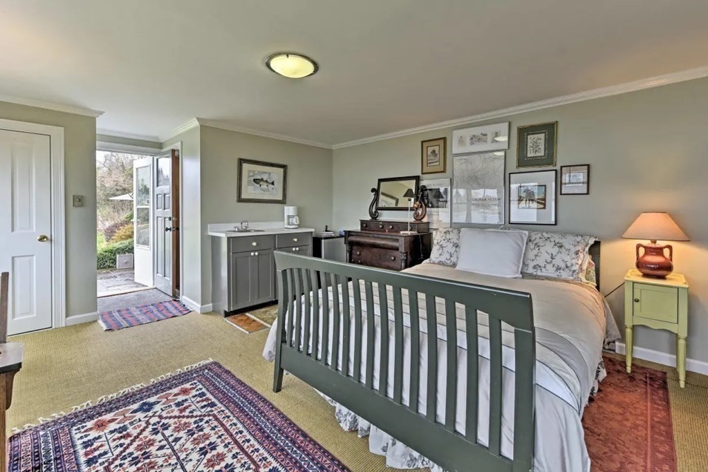232 Lagoon Pond Road Tisbury, MA 02568 - Photo 20 of 31 a bedroom with furniture and a window