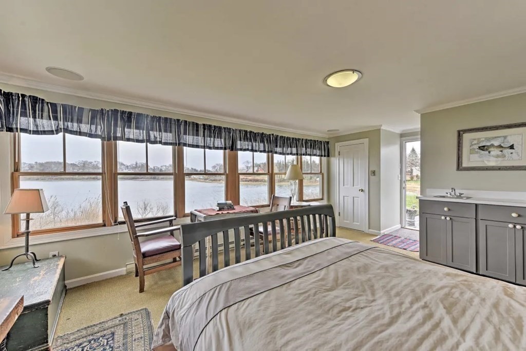 232 Lagoon Pond Road Tisbury, MA 02568 - Photo 21 of 31 a bedroom with a balcony a bed and a large window
